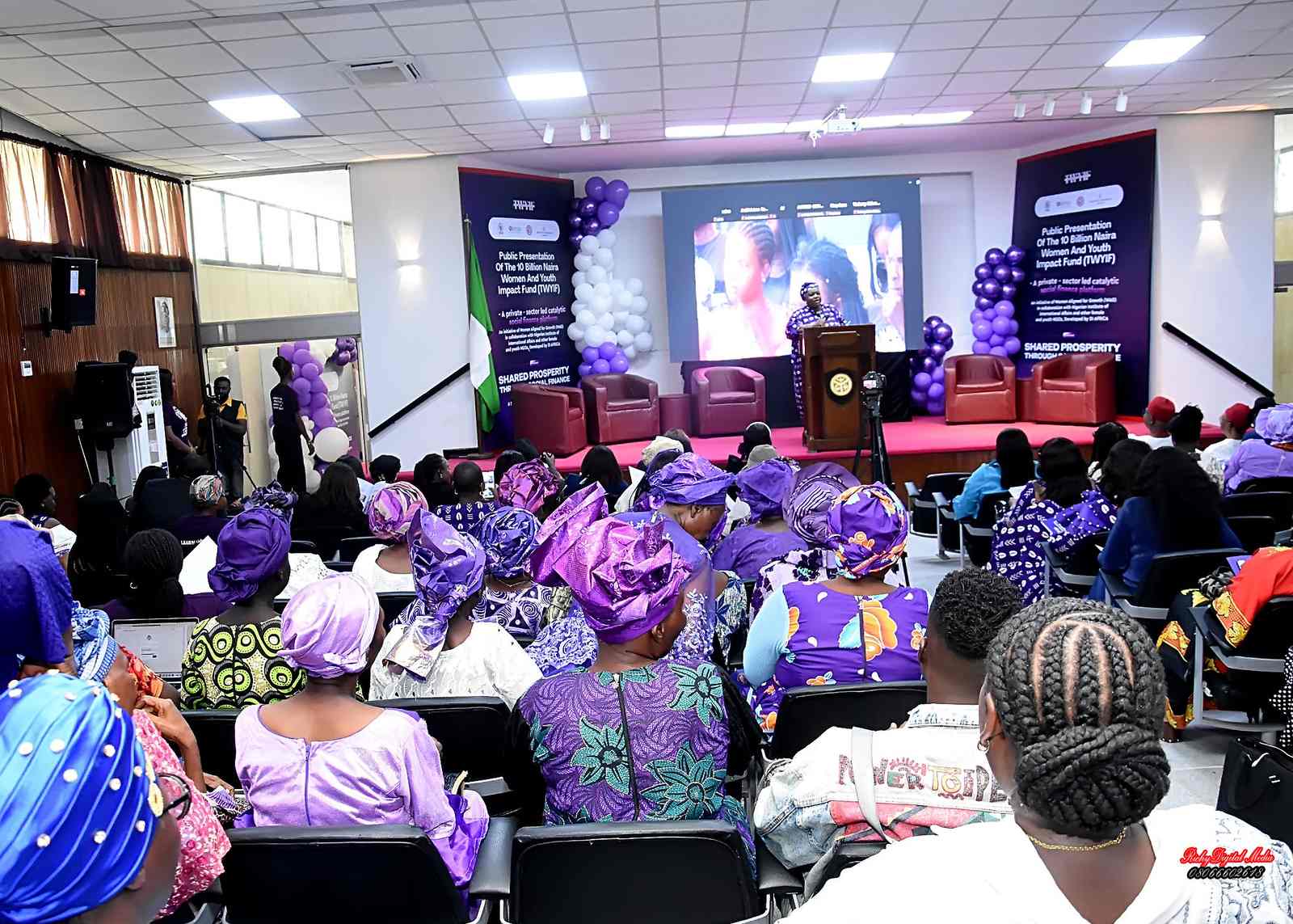 Attendees seated in the hall at the public presentation of the Women and Youth Impact Fund.